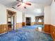 Open-concept living room offers great flow, blue carpeting, natural light and access to other rooms at 2920 Ewell Rd, Lakeland, FL 33811
