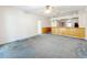 Spacious living room with wood paneling, a door, and partial wall to kitchen at 2920 Ewell Rd, Lakeland, FL 33811