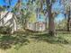 Storage shed in backyard next to home on grass and under lush trees at 2920 Ewell Rd, Lakeland, FL 33811