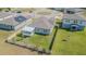 Aerial view of a home with a fenced yard, sunroom addition, and solar panels on a sunny day at 928 Cambridge Dr, Winter Haven, FL 33881