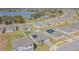 Aerial view showcasing a residential neighborhood with modern homes and a serene lake backdrop at 928 Cambridge Dr, Winter Haven, FL 33881