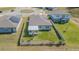 Aerial view of a cozy fenced backyard with a screened in porch and green lawn at 928 Cambridge Dr, Winter Haven, FL 33881