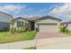 Charming single-story home featuring a well-manicured lawn, brick driveway, and inviting entrance at 928 Cambridge Dr, Winter Haven, FL 33881