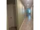 Long hallway with tiled flooring and neutral paint colors at 928 Cambridge Dr, Winter Haven, FL 33881