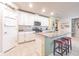 Modern kitchen featuring an island with seating and white cabinets at 928 Cambridge Dr, Winter Haven, FL 33881