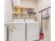 Laundry room featuring a front-load washer and dryer and wooden shelving at 928 Cambridge Dr, Winter Haven, FL 33881
