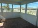Bright sunroom with brick flooring, white walls, and windows offering outdoor views at 928 Cambridge Dr, Winter Haven, FL 33881