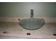 Close-up of a glass bowl sink with a modern faucet on a tile countertop at 114 1St Nw St, Fort Meade, FL 33841