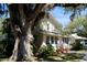 A charming home with a lush green lawn and mature trees offering ample shade at 114 1St Nw St, Fort Meade, FL 33841
