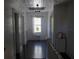 Hallway featuring a window with stained glass and a white ceiling with unique design at 114 1St Nw St, Fort Meade, FL 33841