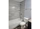 Modern bathroom featuring tiled walls, a bathtub with shower, and updated fixtures at 716 Byni Rdg, Winter Haven, FL 33880