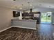 Modern kitchen featuring stainless steel appliances, dark cabinets and granite countertops at 716 Byni Rdg, Winter Haven, FL 33880