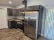 Modern kitchen featuring stainless steel appliances, dark cabinets and granite countertops at 716 Byni Rdg, Winter Haven, FL 33880