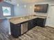 Kitchen with stainless steel dishwasher, modern countertops and dark cabinets at 716 Byni Rdg, Winter Haven, FL 33880