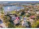 Aerial view of a home in a lakeside community with mature trees and meticulously maintained lawns at 1229 Sebastian Cv, Lake Mary, FL 32746