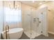 Elegant bathroom featuring a freestanding tub, glass shower and gold fixtures at 1229 Sebastian Cv, Lake Mary, FL 32746