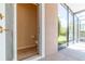 An interior bathroom with a toilet, paper holder, and an exterior view of landscaped property at 1229 Sebastian Cv, Lake Mary, FL 32746