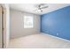 A large bedroom with a blue accent wall and a ceiling fan at 1229 Sebastian Cv, Lake Mary, FL 32746