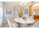 Bright dining room shows modern chandelier, marble table, and arched doorway at 1229 Sebastian Cv, Lake Mary, FL 32746