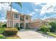 Beautiful home with a well-manicured lawn, lush landscaping, and a grand entryway at 1229 Sebastian Cv, Lake Mary, FL 32746