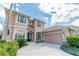 Beautiful home with a well-manicured lawn, lush landscaping, and a grand entryway at 1229 Sebastian Cv, Lake Mary, FL 32746