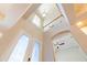 Grand foyer featuring soaring ceilings, decorative glass doors, and an open staircase at 1229 Sebastian Cv, Lake Mary, FL 32746