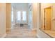 Bright foyer featuring a decorative glass front door and light wood-look flooring at 1229 Sebastian Cv, Lake Mary, FL 32746