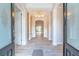 Inviting foyer with wood-look tile flooring, decorative lighting, and an open floor plan at 1229 Sebastian Cv, Lake Mary, FL 32746