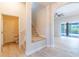 Hallway features stairs, a powder room, and sliding doors to the lanai at 1229 Sebastian Cv, Lake Mary, FL 32746