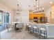 An open-concept living space features a bright kitchen with barstool seating, dining area and outdoor access at 1229 Sebastian Cv, Lake Mary, FL 32746