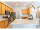 A modern kitchen with stainless steel appliances, light wood cabinets, granite counters and an island at 1229 Sebastian Cv, Lake Mary, FL 32746