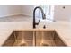 Close-up of a stainless steel dual sink with a modern faucet and marble countertop at 1229 Sebastian Cv, Lake Mary, FL 32746