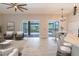 Open-concept living area with sliders to the lanai, adjoining the dining area and kitchen at 1229 Sebastian Cv, Lake Mary, FL 32746