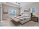Stylish main bedroom with a tray ceiling, a neutral color scheme, and sliding doors to the lanai at 1229 Sebastian Cv, Lake Mary, FL 32746