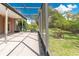 An open patio area features a screened-in enclosure and provides views of the exterior backyard and landscaping at 1229 Sebastian Cv, Lake Mary, FL 32746