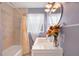 Updated bathroom with a modern vanity, decorative mirror, and tiled shower at 2421 Cypress Ln, Lakeland, FL 33801