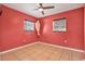 Cozy bedroom with tiled floors, ceiling fan, and dual windows at 2421 Cypress Ln, Lakeland, FL 33801