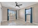 Bedroom features tile floors, neutral walls, and window with blinds at 2421 Cypress Ln, Lakeland, FL 33801