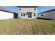 A spacious backyard with a freshly seeded lawn and a view of the home's sliding glass doors at 2506 Linda Knoll Ln, Bartow, FL 33830
