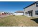 Spacious backyard with a freshly seeded lawn and a covered patio area at 2506 Linda Knoll Ln, Bartow, FL 33830