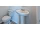 Well-lit half bathroom with pedestal sink and toilet at 2506 Linda Knoll Ln, Bartow, FL 33830