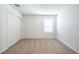 Bedroom with sliding door closet, neutral carpet, and window letting in natural light at 2506 Linda Knoll Ln, Bartow, FL 33830