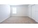 Bedroom with sliding door closet, neutral carpet, and window letting in natural light at 2506 Linda Knoll Ln, Bartow, FL 33830