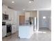 Open kitchen with white cabinetry, stainless steel appliances, and granite countertops at 2506 Linda Knoll Ln, Bartow, FL 33830