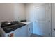 Bright laundry room featuring a washer and dryer, plus a convenient access door at 2506 Linda Knoll Ln, Bartow, FL 33830