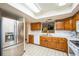 Bright kitchen with stainless steel refrigerator and view to the living room at 9415 Cat Track Trl, Lake Wales, FL 33898