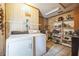 Laundry room area with a washer, dryer, shelving, and storage space at 9415 Cat Track Trl, Lake Wales, FL 33898