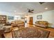 Spacious living room with a classic rug, comfortable seating, and ample natural light at 9415 Cat Track Trl, Lake Wales, FL 33898