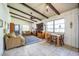Inviting living room featuring a beamed ceiling, tile flooring, and a comfortable seating area at 9415 Cat Track Trl, Lake Wales, FL 33898