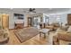 Open-concept living area with hardwood floors, neutral tones, and a view into the adjacent dining space at 9415 Cat Track Trl, Lake Wales, FL 33898